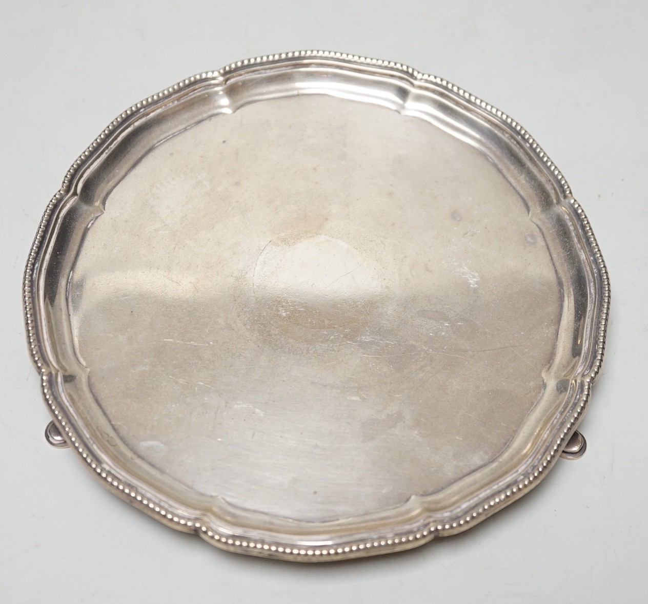 A George V silver waiter, London, 1923, on three hoof feet, 15.4cm, 7oz.